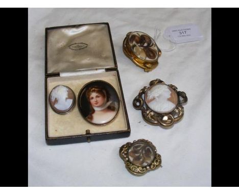A small oval hand painted portrait brooch together with others