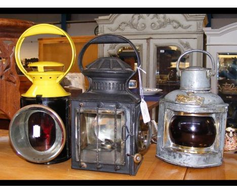 Three old lamps, including a ship's Port light 