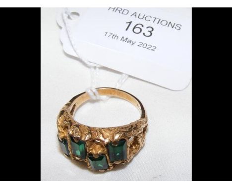 A 14ct gold ring set with four emeralds