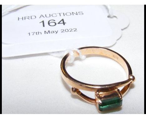 A .585 gold ring set with baguette emerald