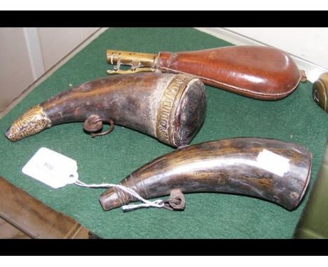 Two antique horn powder flasks together with a leather shot flask