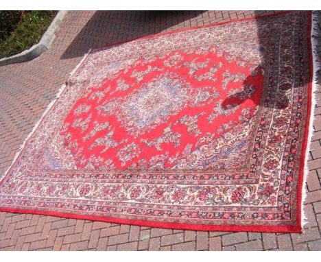 A Middle Eastern bordered carpet with floral design - approx. 360cm x 325cm 