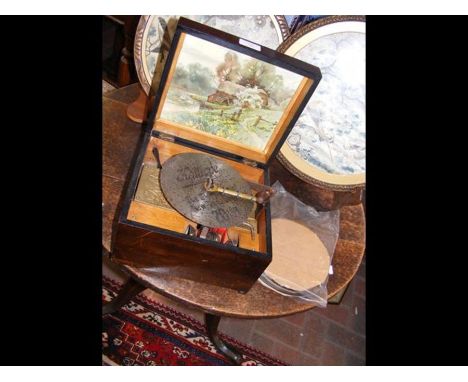A Victorian polyphon with seven inch metal discs and bells - the case measuring 26cm x 23cmCONDITION REPORTworks and plays ok