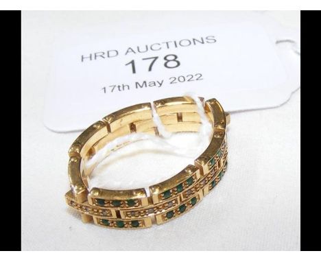 A gold 'bracelet' ring set with diamonds and emeralds