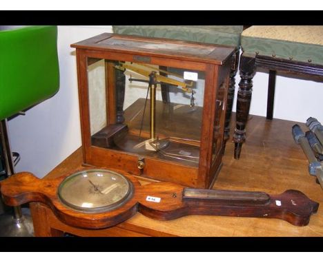 A set of scientific scales, together with wall barometer marked 'Powell, West Cowes' 