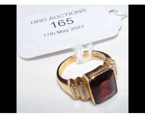 A 14ct gold ring with central garnet