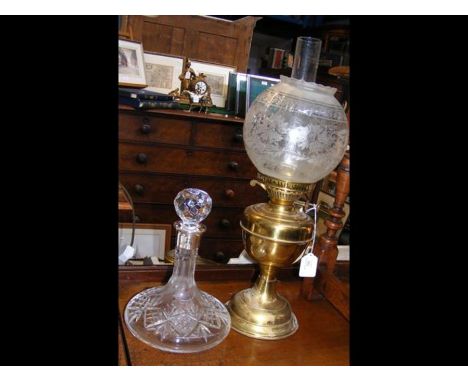 A silver mounted ships decanter together with an oil lamp
