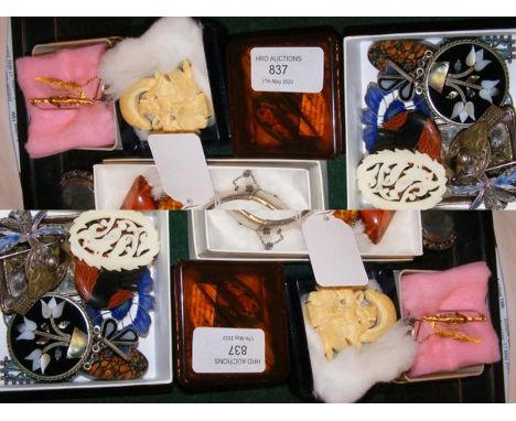 A selection of costume jewellery including brooches, bangle