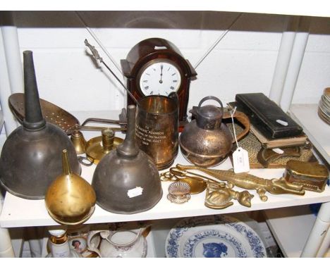 A small mahogany mantel clock in the company of assorted metal ware