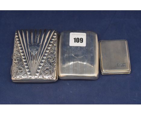 A Victorian silver card case, by Joseph Whitten, Birmingham 1890, with embossed decoration and leather interior; a George V s