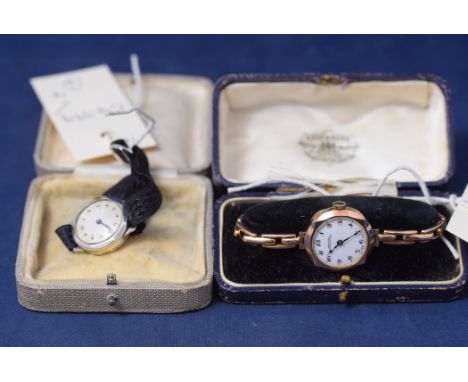 A 9ct. yellow gold lady's wristwatch, by Reid & Sons, Newcastle with white enamel arabic dial in fitted Reid & Sons case; tog