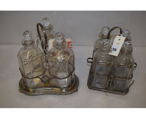 Two silver plated decanter stands, one holding four, the other three, with glass decanters.