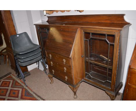 A circa 1930 bureau bookcase with glazed panel doors, the bureau above three long doors raised on cabriole legs, 167cms wide;