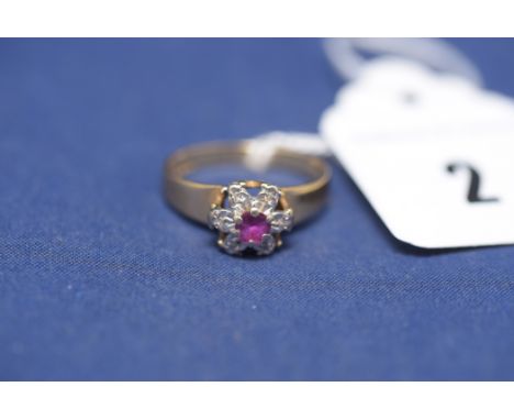 A ruby and diamond cluster ring, on 18ct. yellow gold shank, ring size K, 2.8grms gross.