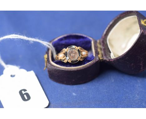 A Victorian mourning ring, on yellow metal shank, with plaited hair panel, black enamel and seed pearl decoration, ring size 