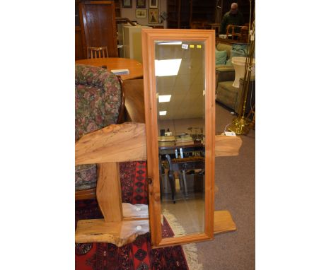 A modern beech wall mirror with shelf and cut-out for two lights; and a pine rectangular bevelled wall mirror.  (2)