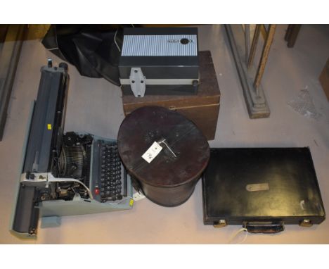A reproduction hat box; a British Olivetti Ltd. typewriter; a Eumig Mk. GL camcorder, made in Austria; and other items.