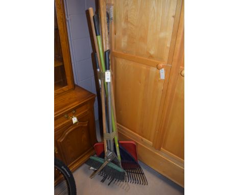 A bundle of gardening tools, to include: rake, shears, snow shovel and other items.