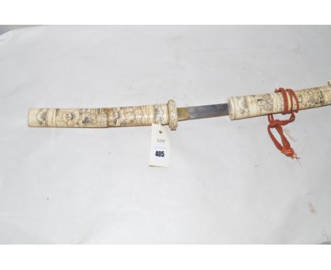 A 20th Century Japanese Tanto sword, with carved bone grip and scabbard depicting warriors.