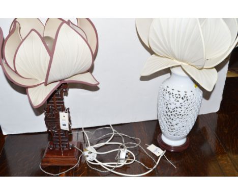 A 20th Century Chinese hardwood table lamp; and a blanc de chine pierced table lamp, both with lotus flower star shades.