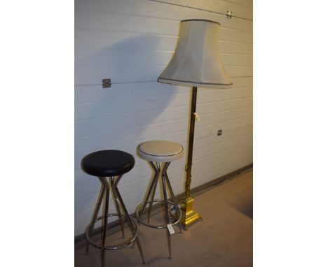 Two breakfast stools, one upholstered in cream and the other in black leatherette, raised on chromed legs; together with a 20