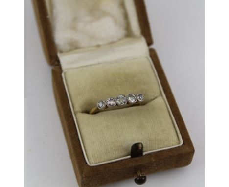 A GRADUATED FIVE STONE DIAMOND RING, brilliant cut, set upon a yellow metal band, size K (with ring box) 