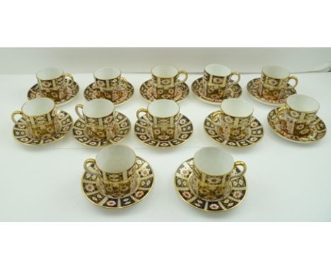 A COLLECTION OF TWELVE ROYAL CROWN DERBY COFFEE CANS WITH SAUCERS decorated in the Imari palette (saucer shapes vary) 