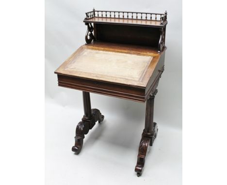 A 19TH CENTURY LADY'S ROSEWOOD WRITING TABLE, having decorative turned galleried shelf upstand, on fancy carved supports, the