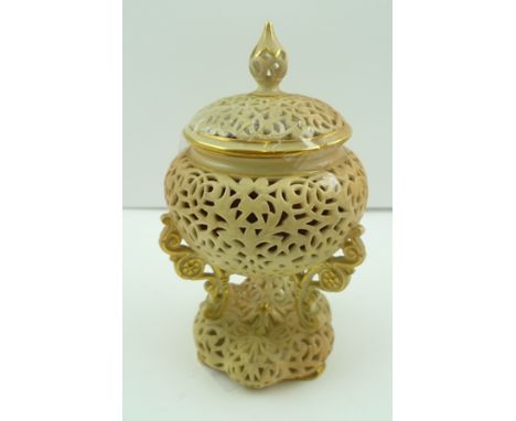 A ROYAL WORCESTER PORCELAIN POT POURRI, of reticulated urn form with cover, having a blush ivory glaze with gilded highlights