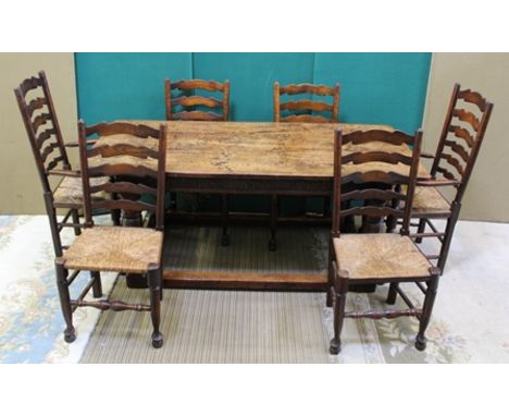 A 17TH CENTURY DESIGN OAK REFECTORY TABLE having lunette chip carved frieze, on turned cup and cover supports with plain stre