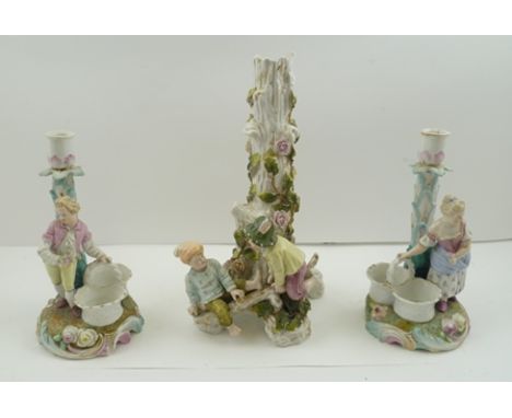 A PAIR OF CONTINENTAL PORCELAIN CANDLE HOLDERS, figuratively mounted with posy baskets, one bears underglaze blue Augustus Re