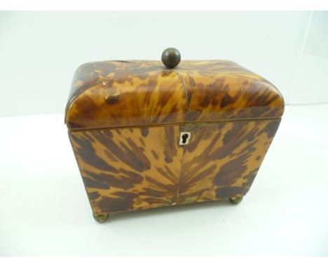 A 19TH CENTURY TORTOISESHELL TEA CADDY, the hinged cover with brass ball handle, opening to reveal twin sections, raised on b