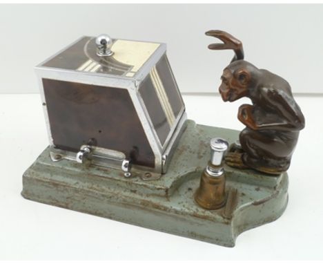 AN ART DECO CIGARETTE DISPENSER AND STRIKE LIGHTER BY "RONSON", the slide mechanism, once activated, revealing a tray which h