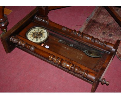 An early 20th century walnut cased Vienna style drop trunk wall clock