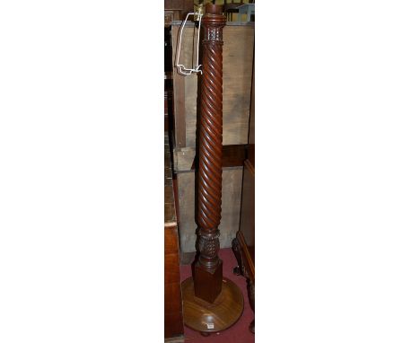 A mahogany spiral reeded standard lamp