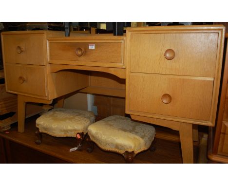 A 1960s G-Plan light oak two piece bedroom suite comprising; triptych mirror back kneehole dressing table, and a three drawer