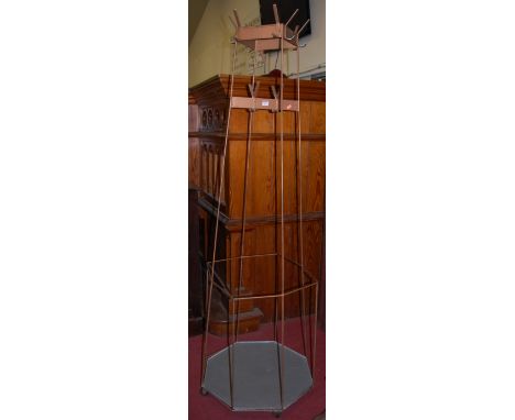 A painted and welded metal freestanding octagonal coat stand on roller castors