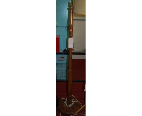 A turned walnut standard lamp