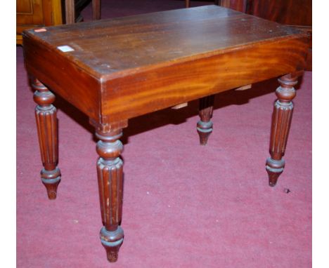 A 19th century mahogany commode, of rectangular form, raised on turned and reeded supports, with fitted interior