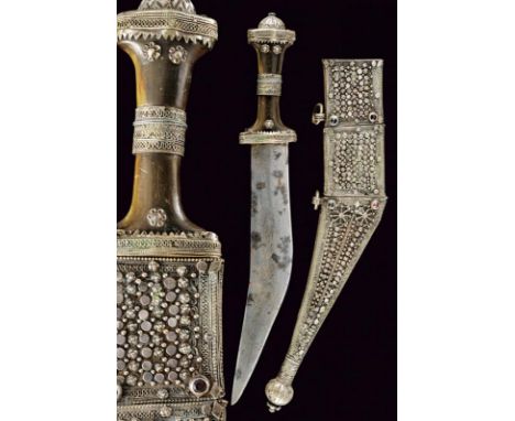 dating: circa 1900 provenance: Oman, Curved, double-edged blade, slightly enlarged at the center. Brown horn grip with silver