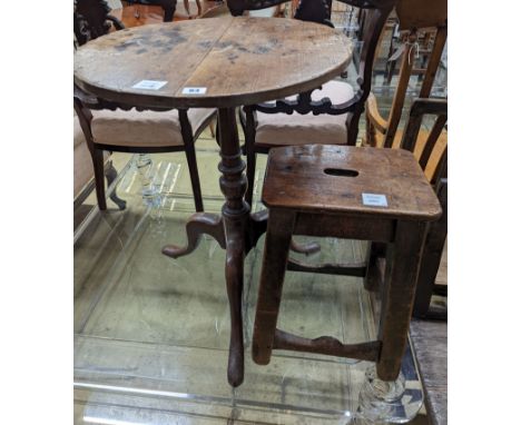 A 19th century oak stool and an oak tripod table, table diameter 53cm, 70cm height