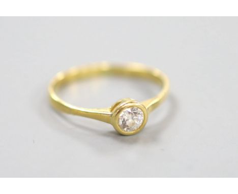 A yellow metal and collet set solitaire diamond ring, size P, gross weight 1.9 grams,the stone weighing approx. 0.20-0.25ct.