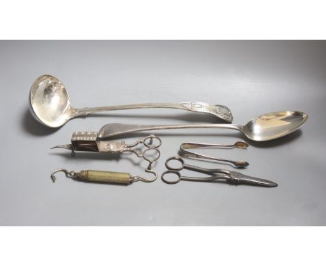 A large plated ladle and basting spoon, two candle snuffers, tongs and spring balance