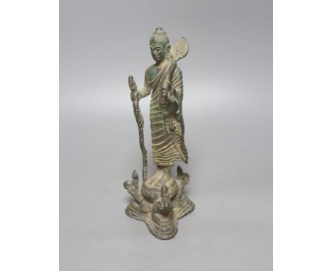 An Indian bronze figure of a standing Buddha, 25cm