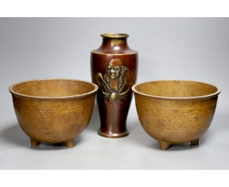 A Japanese bronze 'Daruma' vase and a pair of bronzed aluminium tripod bowls, vase 25 cms high.