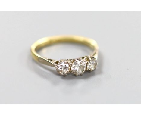 An 18ct &amp; Pt, three stone diamond ring, size M, gross 2.4 grams.
