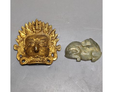 A Chinese jade carving of a resting horse, 7cm and a Himalayan cast gilt-bronze mount
