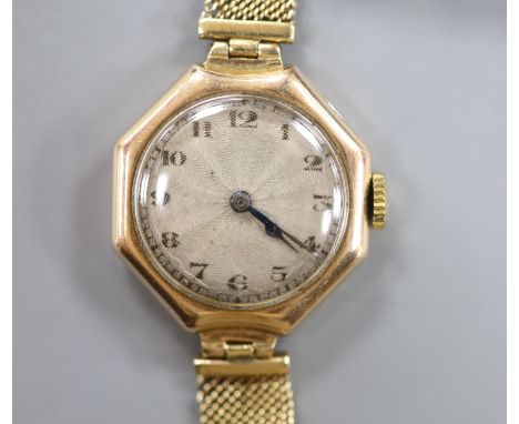 A lady's early 20th century yellow metal manual wind wrist watch, on a 9ct mesh link bracelet,gross 19 grams.