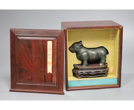 A Chinese gold and silver inlaid bronze figure of a tapir, Han dynasty or later, L. 12cm, excluding hardwood stand and fitted