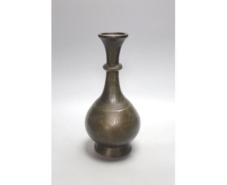 A Middle Eastern Islamic bronze vase, 28 cms high.